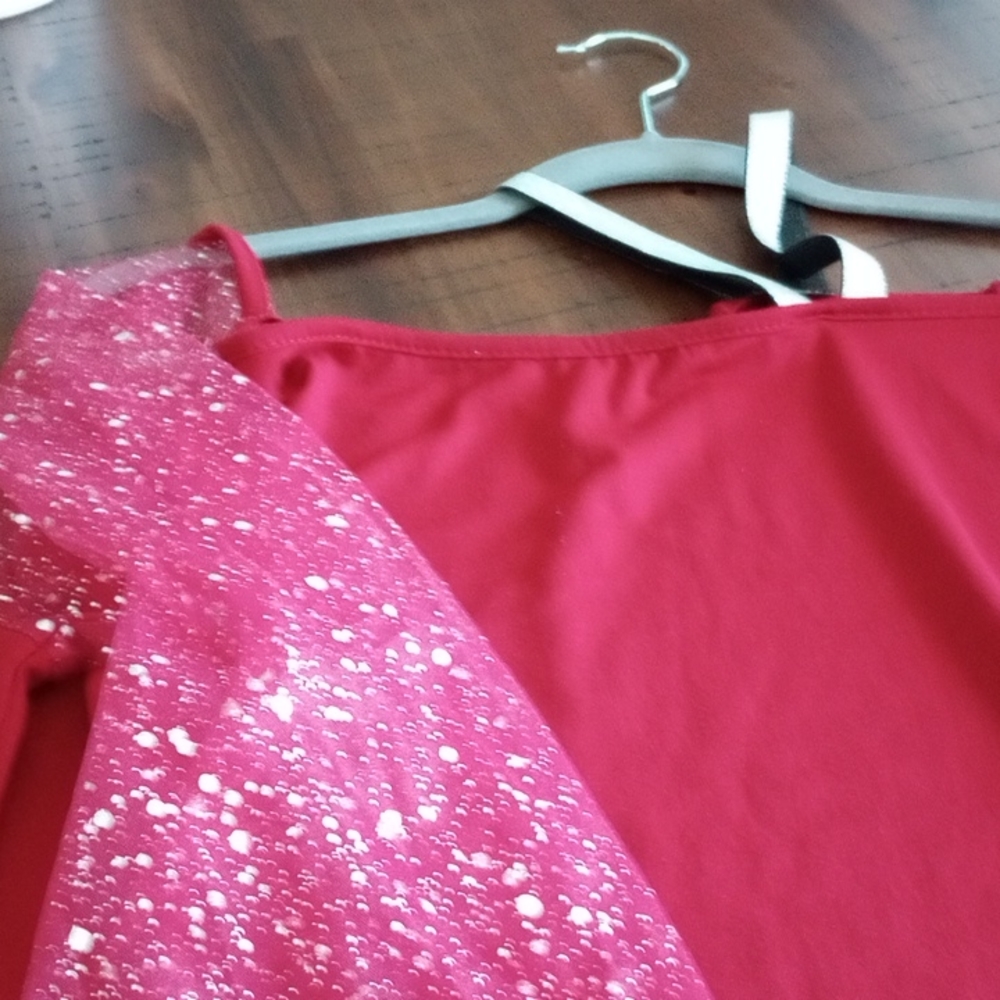 Brand new never worn, silver straps on chest and more of a wine color